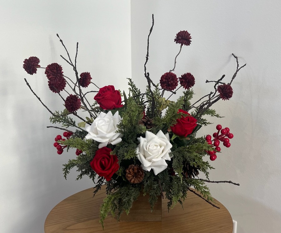 Premium winter arrangement: a wider arrangement of red and white roses, pine, berries and bare branches